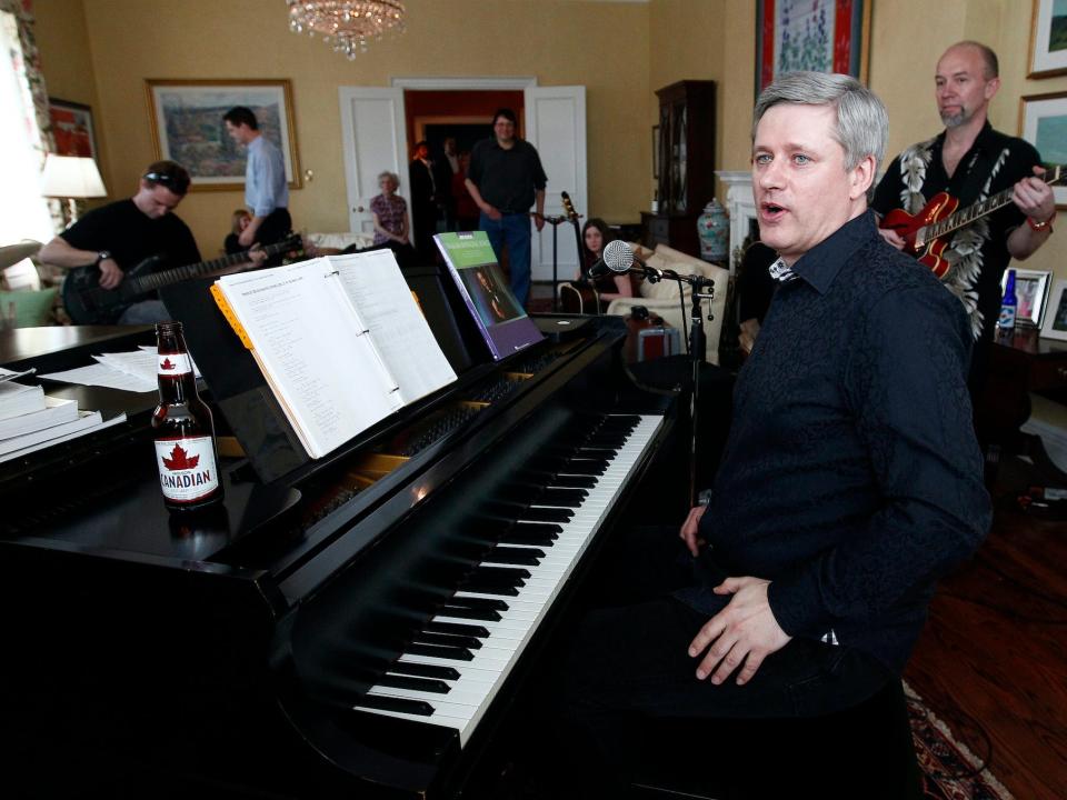 Conservative leader and Canada's Prime Minister Stephen Harper reacts in between songs while practicing with his band "Herringbone" at 24 Sussex Drive, Harper's official residence, in Ottawa April 22, 2011.