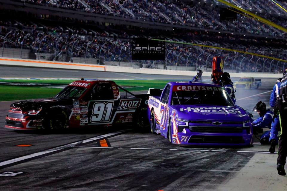 Feb 16, 2024; Daytona Beach, Florida, USA; NASCAR Truck Series driver Rajah Caruth (71) and driver Jack Wood (91) collide on pit road during the Fresh From Florida 250 at Daytona International Speedway. Mandatory Credit: Peter Casey-USA TODAY Sports