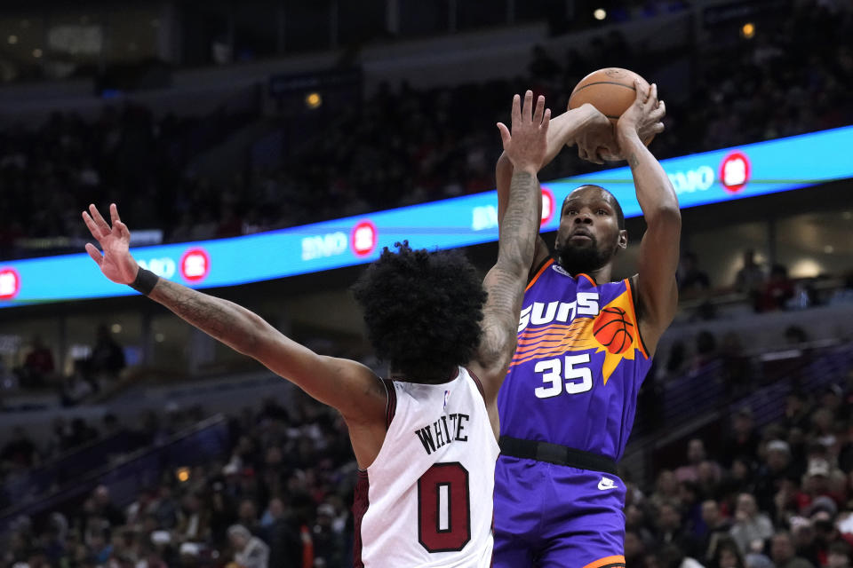 Phoenix Suns' Kevin Durant shoots over Chicago Bulls' Coby White during the first half of an NBA basketball game Friday, March 3, 2023, in Chicago. (AP Photo/Charles Rex Arbogast)