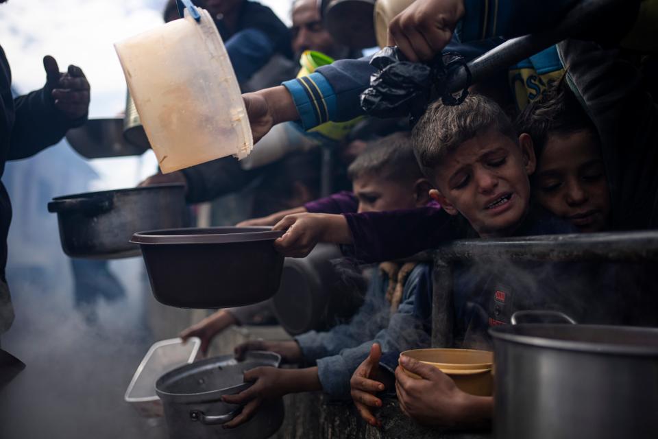 Palestinians line up for a free meal in Rafah, Gaza Strip, on Feb. 16, 2024.