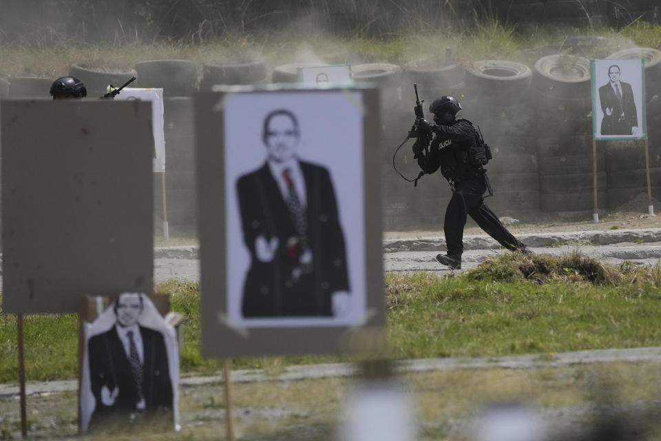 FILE - A police officer takes part in an assimilated operation against organized crime at the end of a ceremony with President Guillermo Lasso who delivered ammunition to the police, in Quito, Ecuador, July 27, 2023. (AP Photo/Dolores Ochoa, File)
