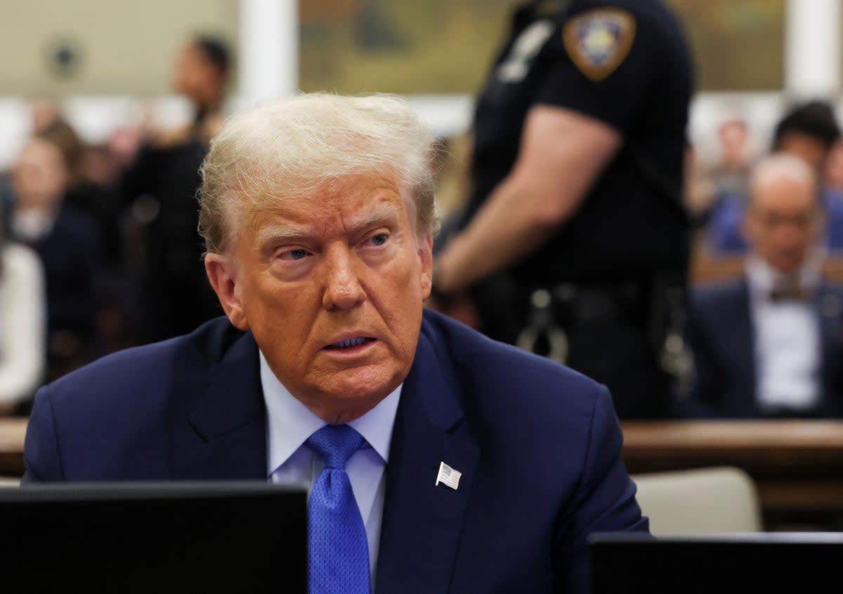 Donald Trump sits with his attorneys before testifying in New York on 6 November.  (REUTERS)