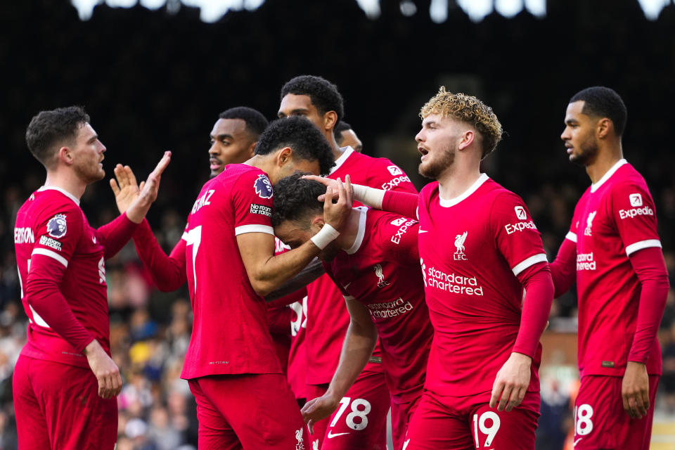 Liverpool's Diogo Jota celebrates with teammates after scoring his side's third goal during the English Premier League soccer match between Fulham and Liverpool at Craven Cottage stadium in London, Sunday, April 21, 2024. (AP Photo/Kirsty Wigglesworth)