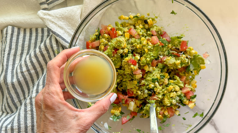 adding lime juice to bowl