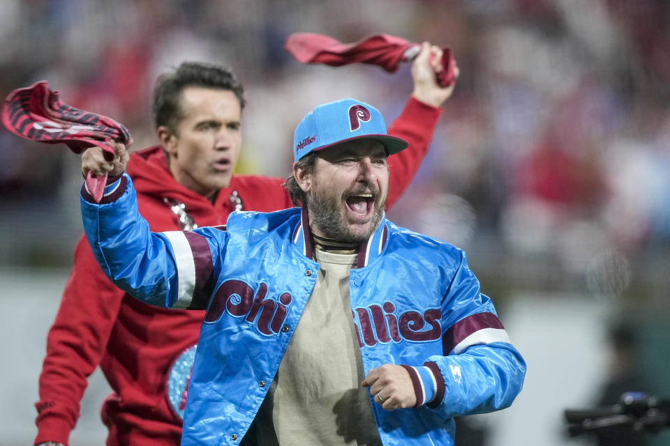 The cast of It's Always Sunny in Philadelphia cheer on the crowd during the fifth inning in Game 2 of the baseball NL Championship Series between the Philadelphia Phillies and the Arizona Diamondbacks in Philadelphia, Tuesday, Oct. 17, 2023. (AP Photo/Brynn Anderson)