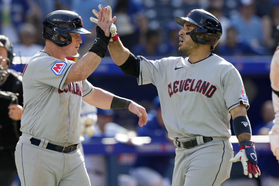 Cleveland Guardians' Ramon Laureano, right, is congratulated by teammate Kole Calhoun after hitting a two-run home run during 11th inning of a baseball game in Toronto, Sunday, Aug. 27, 2023. (Frank Gunn/The Canadian Press via AP)