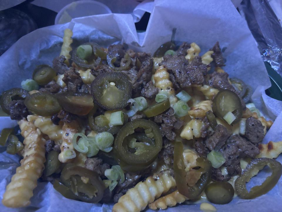 The Fully Loaded Fries ($7.50) are topped with more queso, pieces of juicy steak, jalapeno slices and green onion.