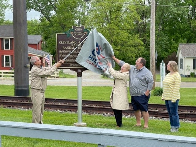 Unveiling the marker are John Kudley, Mayor Ann Womer Benjamin, and Historical Society Members Jason Coleman and Gwen Tomasko