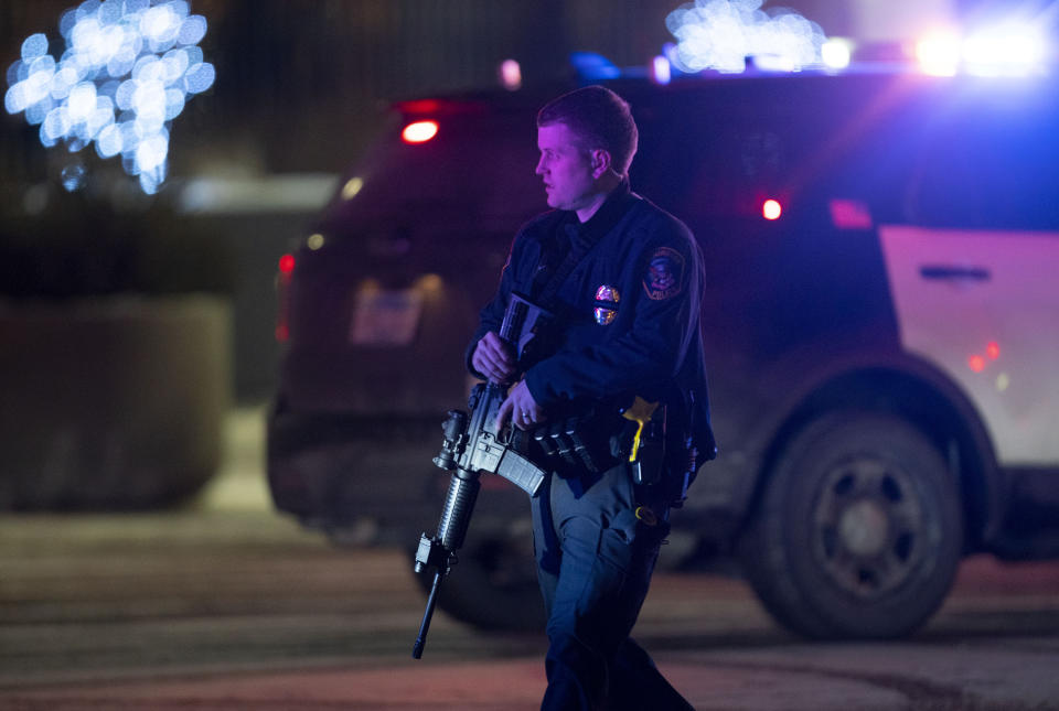 FILE - A police officer carrying a rifle exits the Mall of America following a shooting on Dec. 31, 2021, in Bloomington, Minn. Advocates say permitless carry makes people safer. Opponents say it makes it more dangerous for ordinary people, and for police officers. (Alex Kormann/Star Tribune via AP, File)