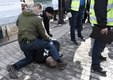 A man is detained after trying to hit Finnish Foreign Minister Timo Soini at the Korson Maalaismarkkinat country fair in Vantaa, Finland March 24, 2019. Lehtikuva/Heikki Saukkomaa via REUTERS ATTENTION EDITORS - THIS IMAGE WAS PROVIDED BY A THIRD PARTY. NO THIRD PARTY SALES. NOT FOR USE BY REUTERS THIRD PARTY DISTRIBUTORS. FINLAND OUT. NO COMMERCIAL OR EDITORIAL SALES IN FINLAND.