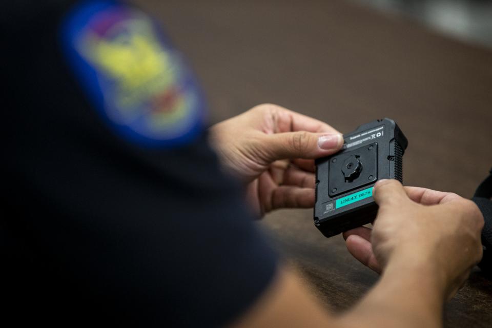 A Phoenix police officer receives an Axon body camera on Thursday, June 20, 2019, at the Phoenix Police Department South Mountain Precinct in Phoenix.