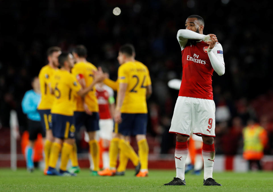 <p>Soccer Football – Europa League Semi Final First Leg – Arsenal vs Atletico Madrid – Emirates Stadium, London, Britain – April 26, 2018 Arsenal’s Alexandre Lacazette looks dejected as Atletico Madrid players celebrate at the end of the match Action Images via Reuters/Andrew Couldridge </p>