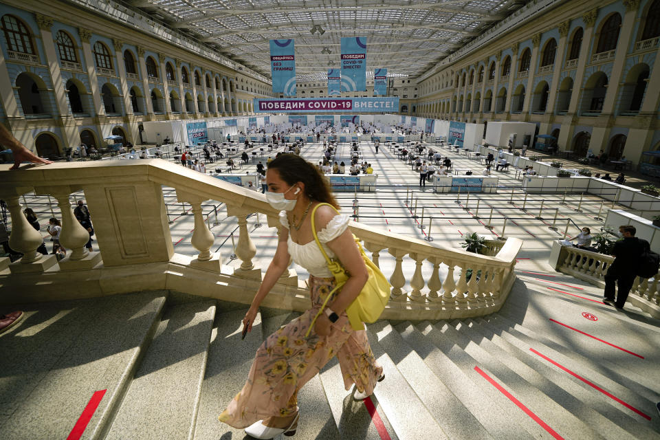 FILE - A woman climbs the stairs to queue for a COVID-19 vaccine at a vaccination center in Gostiny Dvor, a huge exhibition center, in Moscow, Russia, July 13, 2021. On Monday, the U.S. will implement a new air travel policy to allow in foreign citizens who have completed a course of a vaccine approved by the Food and Drug Administration or the World Health Organization. That leaves people in Mexico, Hungary, Russia and elsewhere who received the non-approved Russian Sputnik V vaccine or the China-produced CanSino vaccine ineligible to board U.S.-bound flights. (AP Photo/Alexander Zemlianichenko, File)