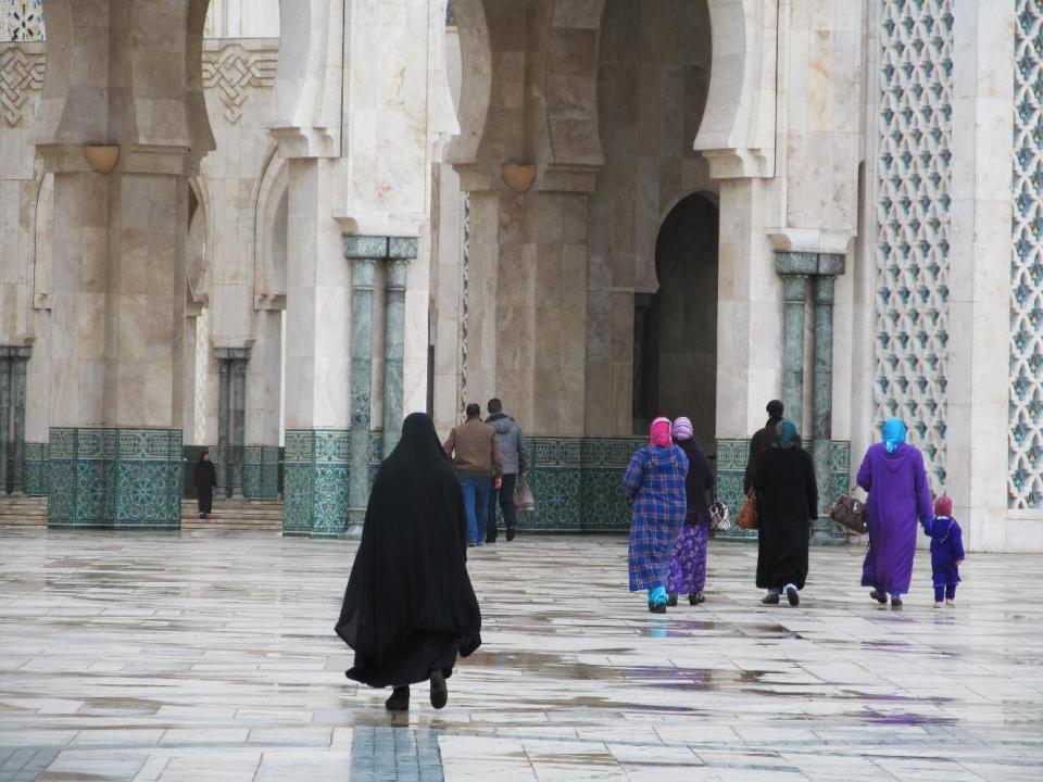 This January 2013 photo shows women about to enter Casablanca's monumental Hassan II mosque in Morocco. Many Moroccan women wear the traditional djellaba, or hooded tunic. (AP Photo/Giovanna Dell'Orto)