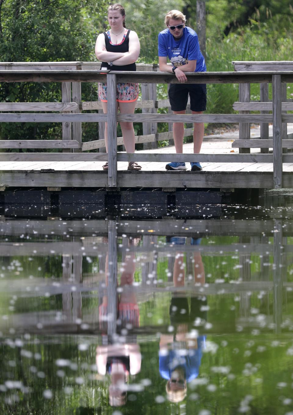 Anita Eckrose and Eric Trempe stand on the turtle pond dock at Gordon Bubolz Nature Preserve on Friday July 1, 2020, in Grand Chute, Wis.