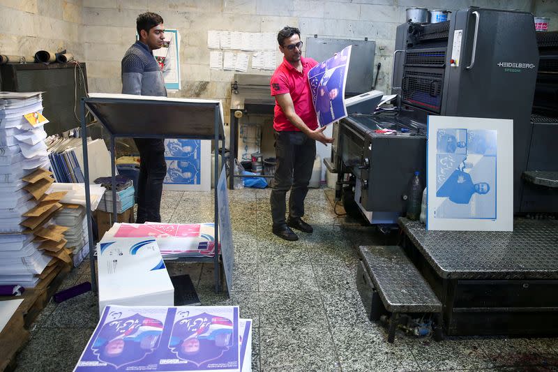 Parliamentary election campaign posters prepare at a publication store in Tehran