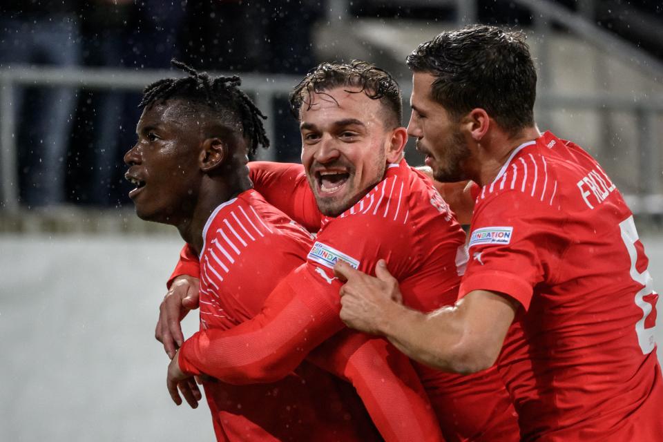 Switzerland's forward Breel Embolo (L) celebrates scoring the 2-0 goal with teammates midfielder Xherdan Shaqiri (C) and midfielder Remo Freuler (R), who scored the 1-0 goal, during the UEFA Nations League League A group 2 football match between Switzerland and Czech Republic at Kybunpark stadium in St. Gallen on September 27, 2022. (Photo by Fabrice COFFRINI / AFP) (Photo by FABRICE COFFRINI/AFP via Getty Images)