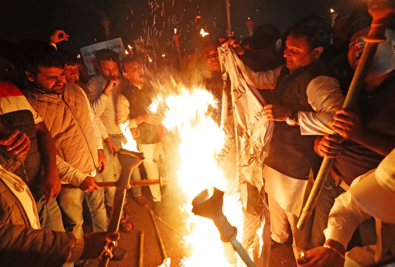 Members of the youth wing of India's main opposition Congress party burn a copy of Citizenship Amendment Bill during a protest in New Delhi