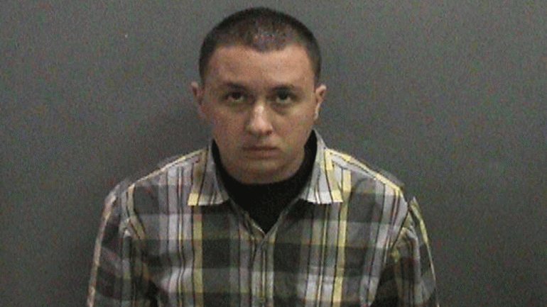 Darreck Michael Enciso is seen in a booking photo released by the Orange County District Attorney's Office.