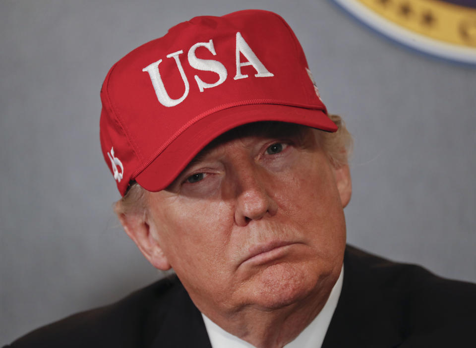 FILE - In this March 2, 2017, file photo, President Donald Trump listens during a briefing on nuclear aircraft carrier Gerald R. Ford at Newport News Shipbuilding in Newport, Va. Trump’s vision of America’s tomorrows looks much like its yesterdays. He loves “beautiful” coal. “Beautiful” warships. And “those four beautiful words: MADE IN THE USA!” He speaks of the country’s might as measured by its steel mills, farms and cars rolling off Detroit assembly lines. (AP Photo/Pablo Martinez Monsivais, File)