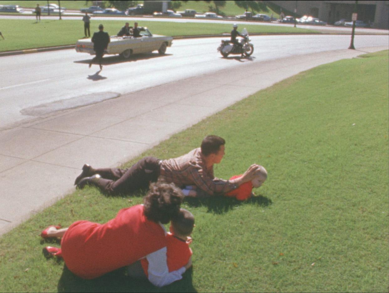 Bill and Gayle Newman dropped to the ground and covered their children, Clayton and Billy, immediately following the assassination of President John F. Kennedy in Dallas, Nov. 22, 1963.