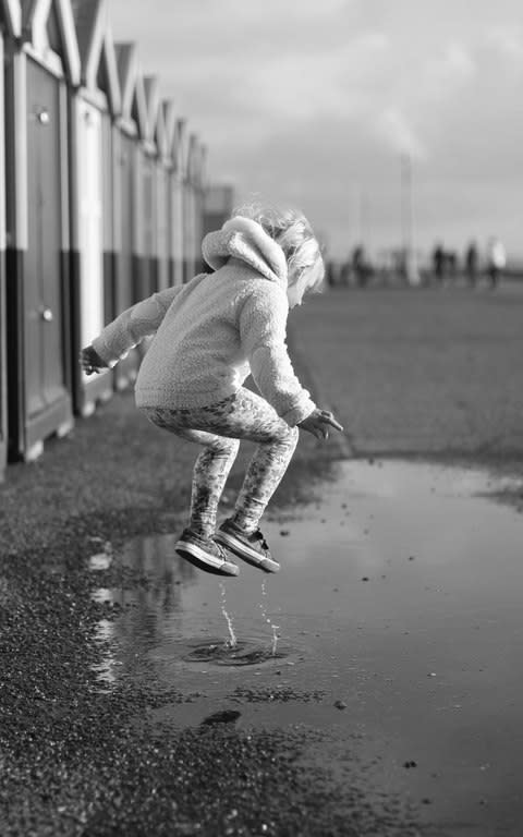 Richard Streeter’s daughter jumping in puddles on Hove seafront. - Credit: Richard Streeter/This Is Britain