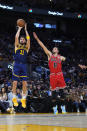 Golden State Warriors guard Klay Thompson (11) shoots next to Chicago Bulls guard Zach LaVine (8) during the first half of an NBA basketball game in San Francisco, Friday, Dec. 2, 2022. (AP Photo/Godofredo A. Vásquez)