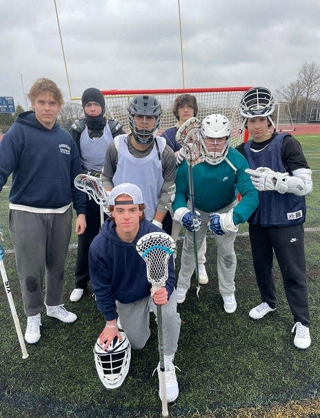 Members of the Somerset Berkley boys lacrosse team during a break at practice at Somerset Berkley Regional High School in Somerset on April 4, 2024.