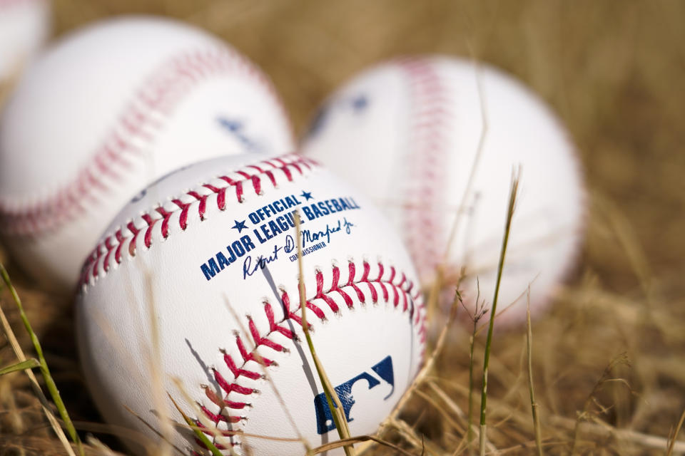 Official MLB baseballs lie on the grass of the MLB First Pitch Festival, at the Queen Elizabeth Olympic Park, in London, Thursday, June 22, 2023. Britain's relative success at the World Baseball Classic and the upcoming series between the Chicago Cubs and St. Louis Cardinals has increased London's interest about baseball. The sport's governing body says it has seen an uptick in interest among kids. (AP Photo/Alberto Pezzali)