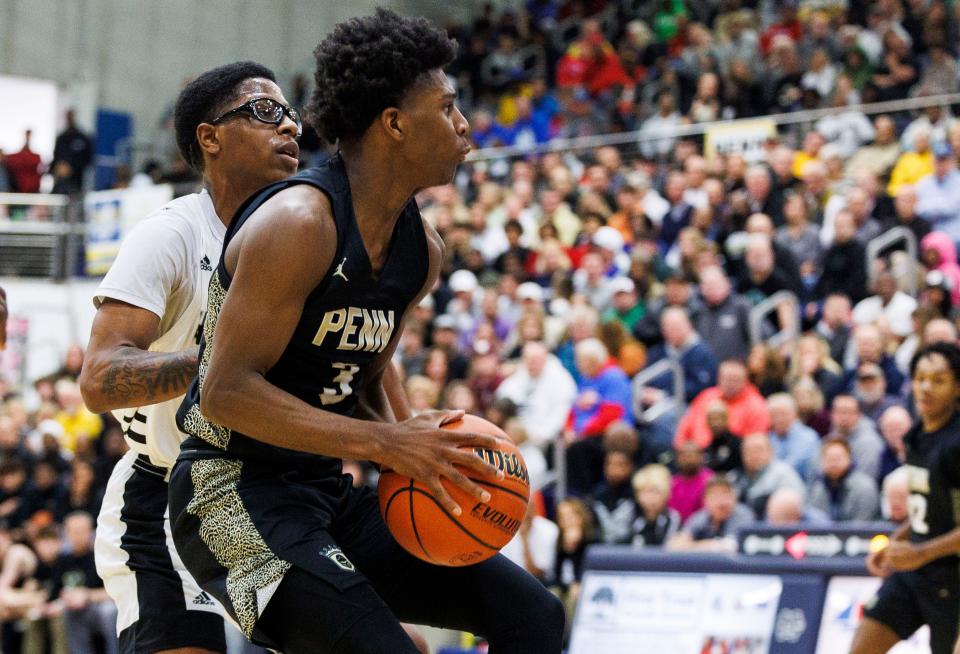 Penn's Markus Burton (3)  drives to the basket as Hammond Central's  Matt King (5) defends during the Penn-Hammond Central high school 4A Semi-State Semi-Final basketball game on Saturday, March 18, 2023, at Michigan City High School in Michigan City, Indiana.