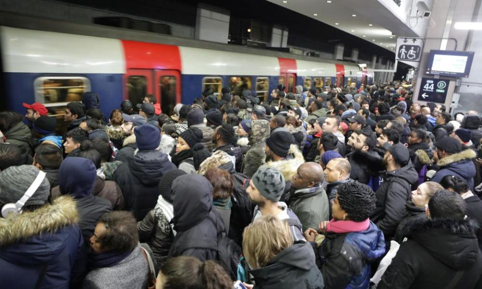 Commuters wait on a platform at the Gare du Nord RER station in Paris