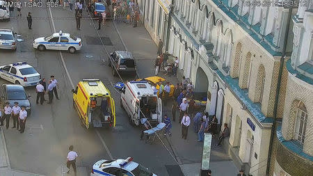 Police officers, investigators and members of emergency services work at the site of an accident after a taxi ran into a crowd of people in central Moscow, Russia June 16, 2018. Moscow Traffic Management Centre Press Service/Handout via REUTERS