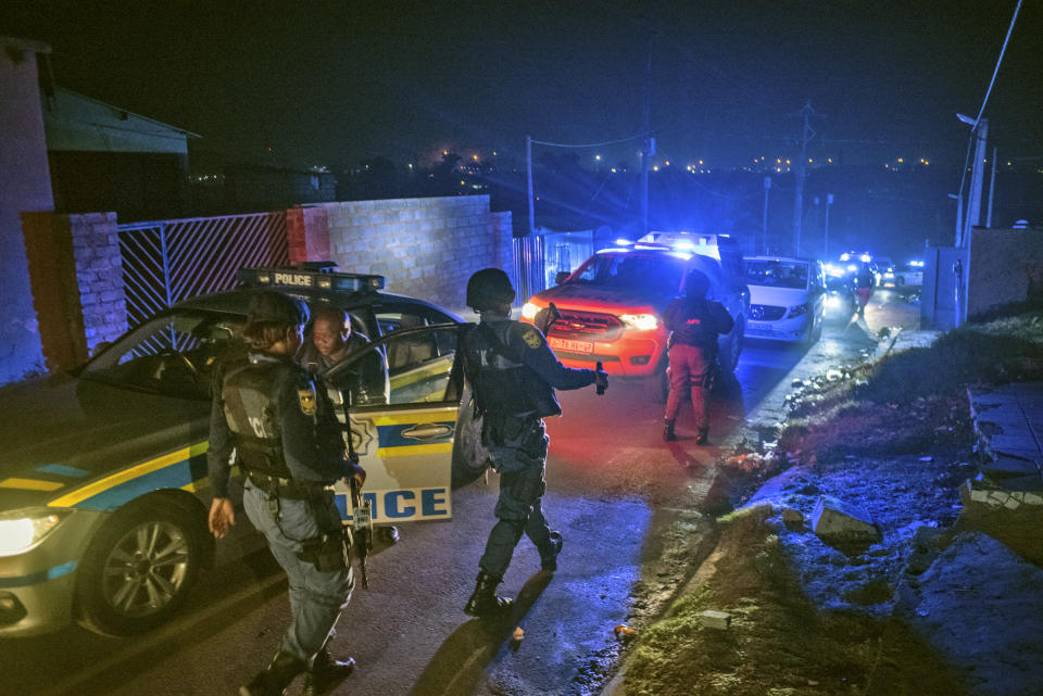 Police patrol an area in Soweto, South Africa, Tuesday, July 12, 2022 in search of illegal firearms following the weekend shooting in a bar which claimed the lives of 16 people. South African police are searching for illegally-held guns in patrols of Johannesburg's Soweto township, following a spate of bar shootings that have rocked the nation. (AP Photo)