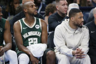 Milwaukee Bucks forward Khris Middleton (22) sits on the bench next to guard Damian Lillard, right, during the second half of an NBA basketball game Friday, April 12, 2024, in Oklahoma City. (AP Photo/Nate Billings)