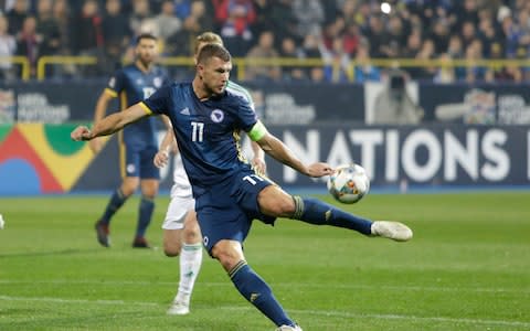 Bosnia's Edin Dzeko takes a shot during the UEFA Nations League soccer match between Bosnia and Northern Ireland - Credit: Amel Emric/AP