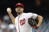 FILE - In this July 25, 2019, file photo, Washington Nationals starting pitcher Max Scherzer throws to the Colorado Rockies during a baseball game in Washington. Three-time Cy Young Award winner Max Scherzer says he is “ready to get in a game” for the Washington Nationals and come off the injured list. Scherzer played catch at Nationals Park on Wednesday, Aug. 14. a day after throwing the equivalent of about two innings in a simulated game, and said he felt able to return to action from a back muscle problem. (AP Photo/Patrick Semansky, File)