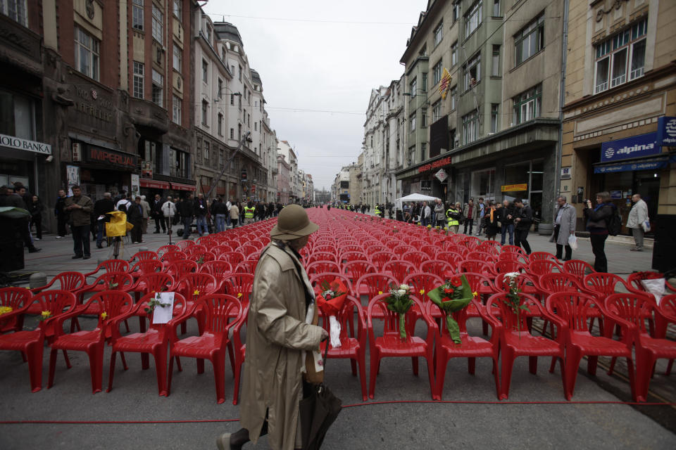 Red chairs are displayed along a main street in Sarajevo as the city marks the 20th anniversary of the start of the Bosnian war on Friday, April,6, 2012. City officials have lined up 11,541 red chairs arranged in 825 rows along the main street that now looks like a red river representing the 11,541 Sarajevans who were killed during the siege.(AP Photo/Amel Emric)