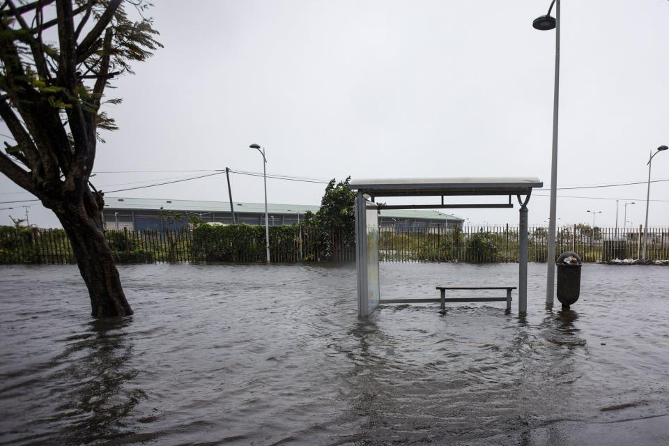 <p>A flooded road and a bus stop are pictured on Boulevard Chanzy in downtown Pointe-a-Pitre on Sept. 19, 2017 in the French territory of Guadeloupe after the passage of Hurricane Maria. (Photo: Cedrick Isham Calvados/AFP/Getty Images) </p>