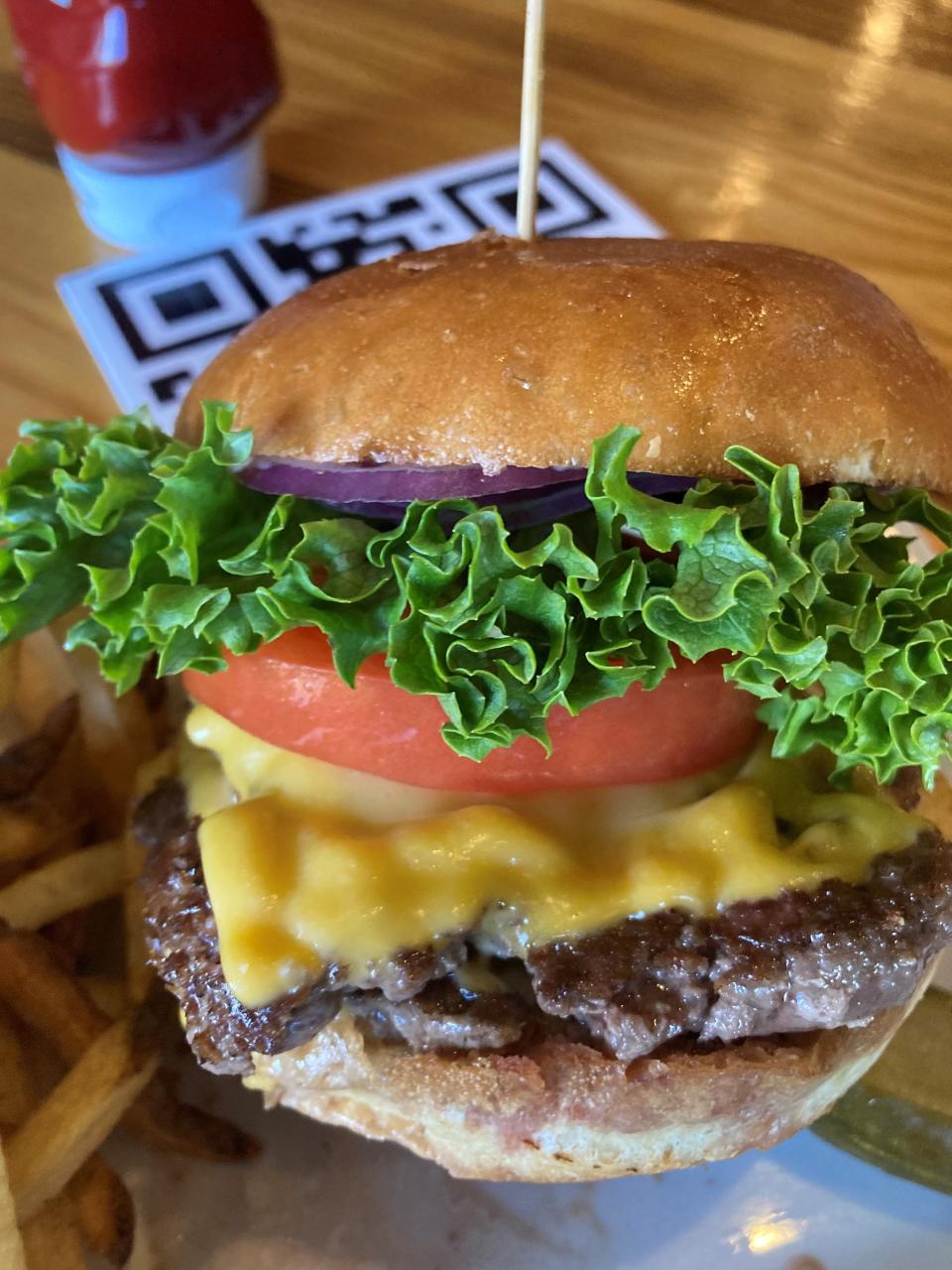 Classic burger at The Burger Loft in New City with American cheese, lettuce, onion and tomato. Photographed Jan. 20, 2022.