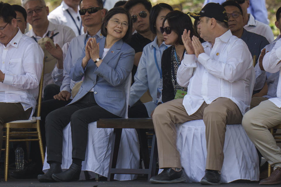 Taiwan's President Tsai Ing-wen, left, and Guatemala's President Alejandro Giammattei, applaud a performance during their visit to the Mayan site Tikal, in Peten, Guatemala, Saturday, April 1, 2023. Tsai is in Guatemala for an official three-day visit. (AP Photo/Moises Castillo)