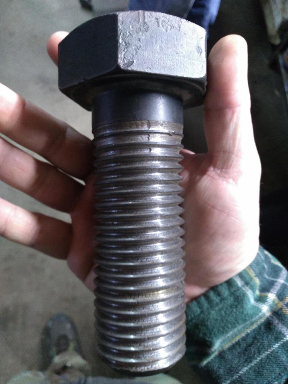 a hand holding a giant bolt