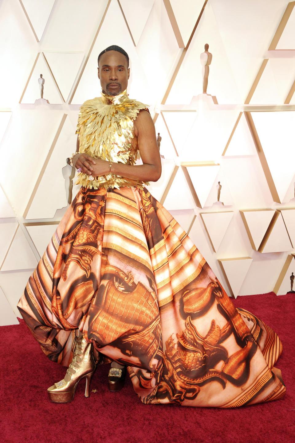 Porter wearing an orange and yellow gown on the red carpet