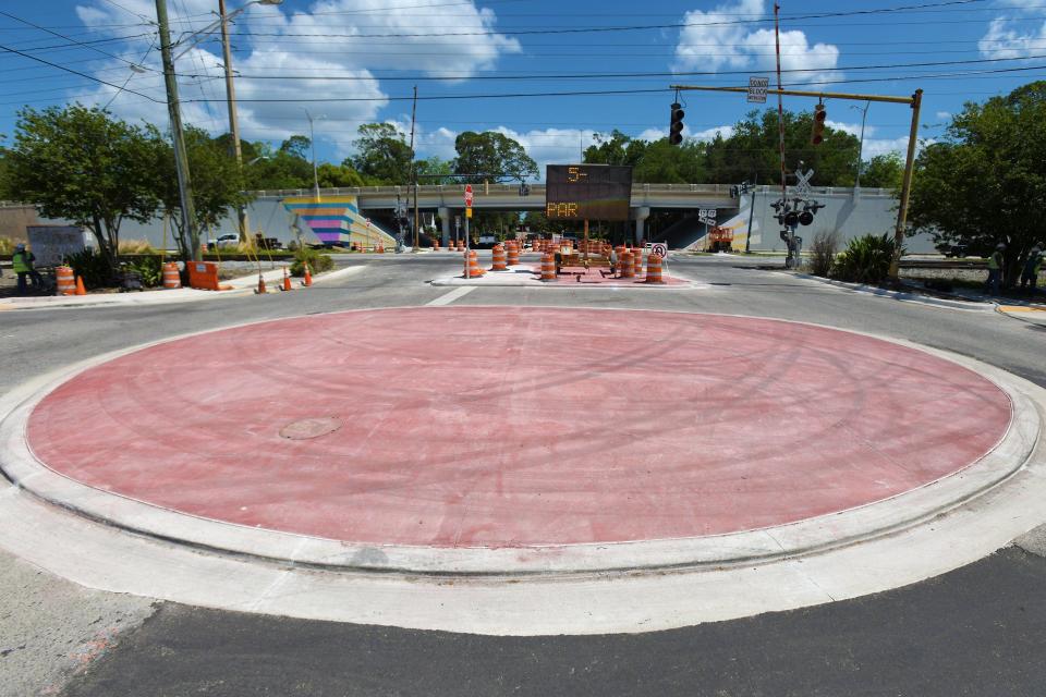 The center of the new roundabout on Edgewood Ave. at the start the Murray Hill business district with the Roosevelt Blvd. overpass in the background. Jacksonville artist David Nackashi is working on his latest project paint the Murray Hill facing side of the Roosevelt Blvd. overpass over Edgewood Ave. Monday, April 29, 2024. The mural is part of the roundabout road project between the overpass and the start of the Murray Hill business district, and because of that, the Department of Transportation restricting the use of symbols, faces, signs or forced perspective could not be used in the artwork so Nackashi used geometry as the springboard for his inspiration. [Bob Self/Florida Times-Union]