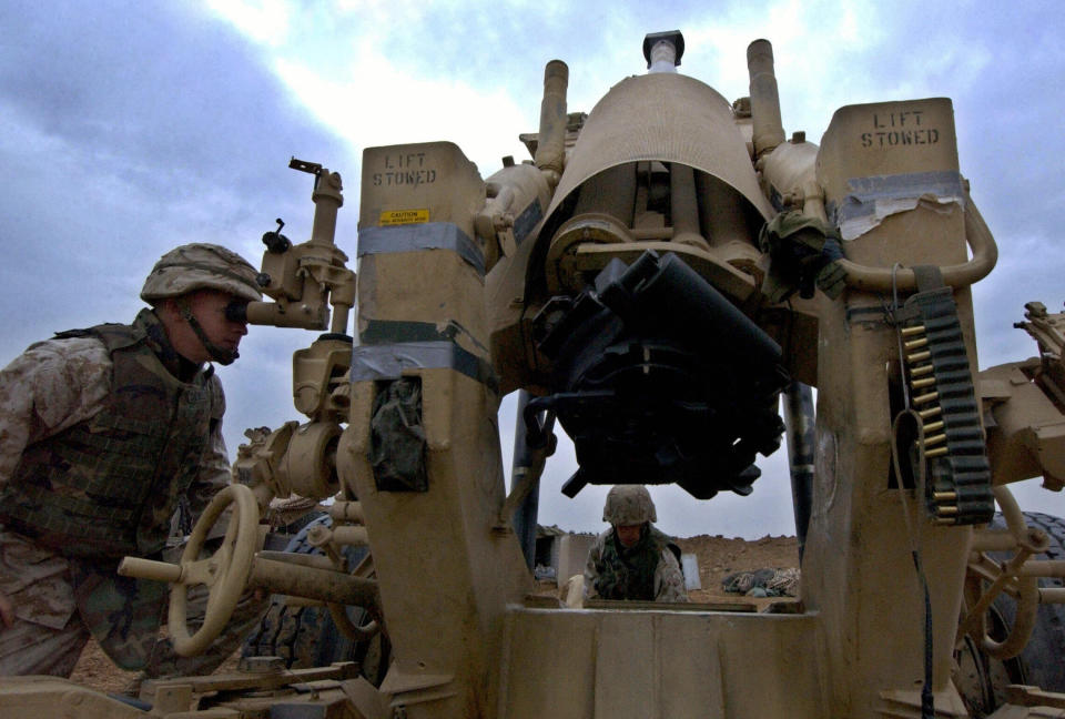 US Marines adjust an artillery at their camp at the edge of the restive city if Fallujah, west of Baghdad, Dec. 16,  2004.  The continuing battles between Marines and insurgents in Fallujah are hampering reconstruction and the return of civilians, a Marines officer said.    (Photo: Tauseef Mustafa/AFP/Getty Images)