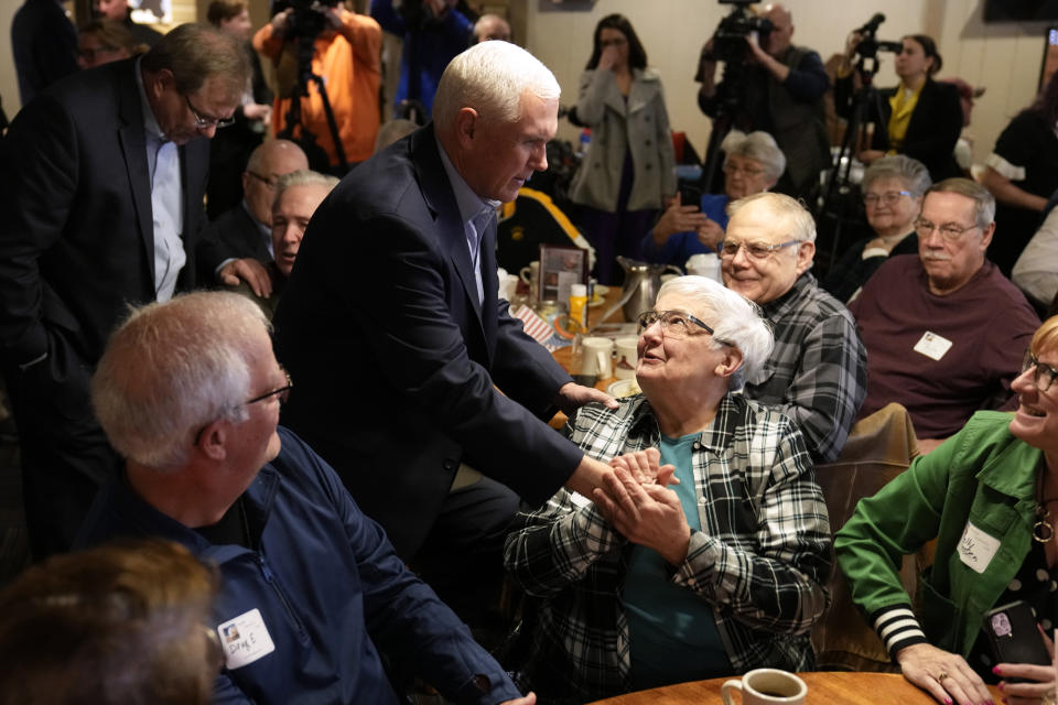 FILE - Former Vice President Mike Pence greets audience members at the Westside Conservative Club Breakfast, March 29, 2023, in Urbandale, Iowa. As Mike Pence approaches a likely 2024 run for president, he's opening up to audiences about the parts of his career before he served as Donald Trump's vice president. He hopes his 12 years in Congress and four years as Indiana governor will project the record of a conservative fighter. (AP Photo/Charlie Neibergall, File)