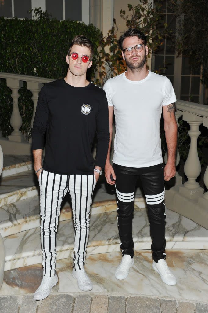 <p>Andrew Taggart (L) and Alex Pall coordinated their outfits with striped pants and opposite color schemes. (Photo by Donato Sardella/Getty Images for BALMAIN) </p>