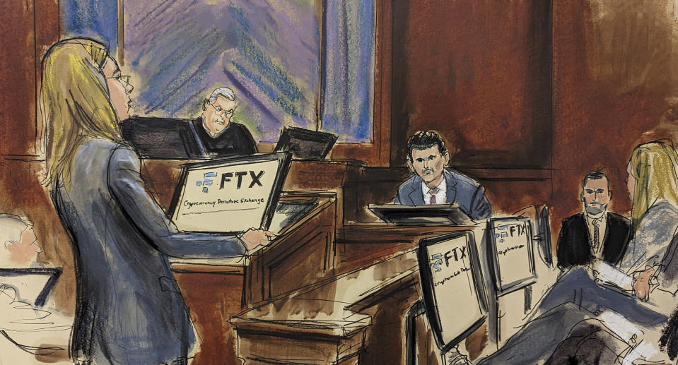 In this courtroom sketch, FTX founder Sam Bankman-Fried, background center, is cross examined by U.S. Assistant Attorney Danielle Sassoon, left, while Judge Lewis Kaplan listens, background second left, in Manhattan federal court, Monday, Oct. 30, 2023, in New York. Members of the jury are seated at right. (Elizabeth Williams via AP)