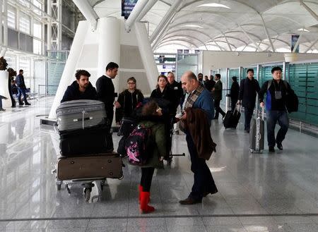 Fuad Sharef Suleman and his family push their belongings after returning to Iraq from Egypt, where they were prevented from boarding a plane to the U.S., following U.S. President Donald Trump's decision to temporarily bar travellers from seven countries, including Iraq, at Erbil International Airport, Iraq, January 29, 2017. REUTERS/Ahmed Saad