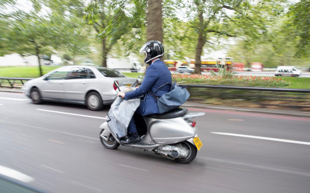 Scooter commuter in traffic