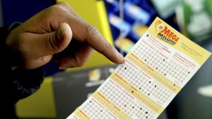 A Mega Millions lottery slip is displayed at Lucky Mart in Chicago on Tuesday. After nearly three months of lottery losing, the Mega Millions jackpot has swelled to $1.1 billion. The odds of winning the top lottery prize are formidable at 1 in 302.6 million. (Photo: Teresa Crawford/AP)